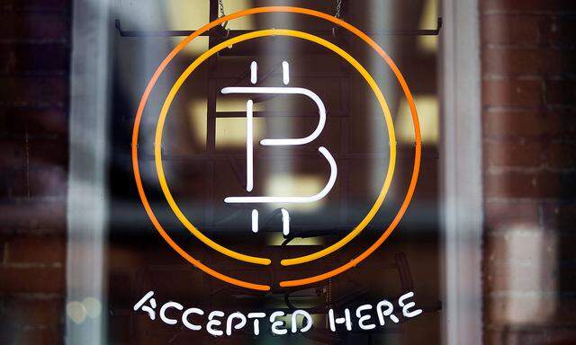 FILE PHOTO - A Bitcoin sign is seen in a window in Toronto