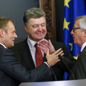 European Council President Tusk, European Commission President Juncker and Ukrainian President Poroshenko react during a news conference after their meeting in Kiev