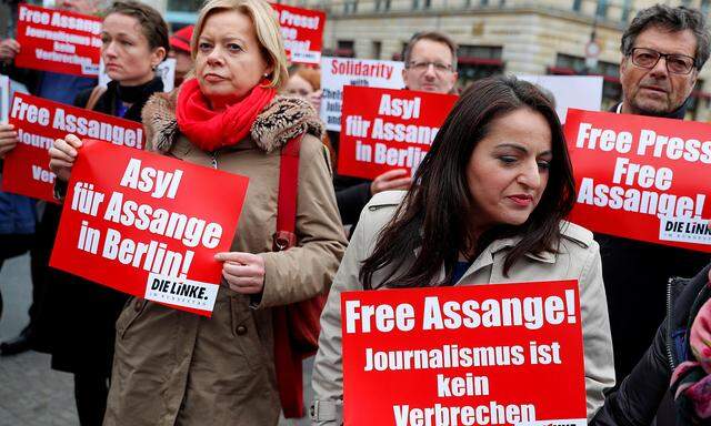 German MPs Gesine Loetzsch, Sevim Dagdelen and Diether Dehm from the left-wing party 'Die Linke' take part in a protest against the arrest of WikiLeaks founder Julian Assange, near the British embassy in Berlin