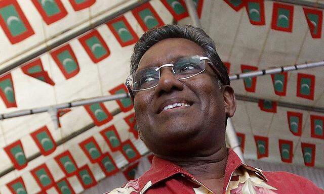 Maldives presidential candidate and former president Mohamed Waheed smiles during a political meeting with his supporters  in Male