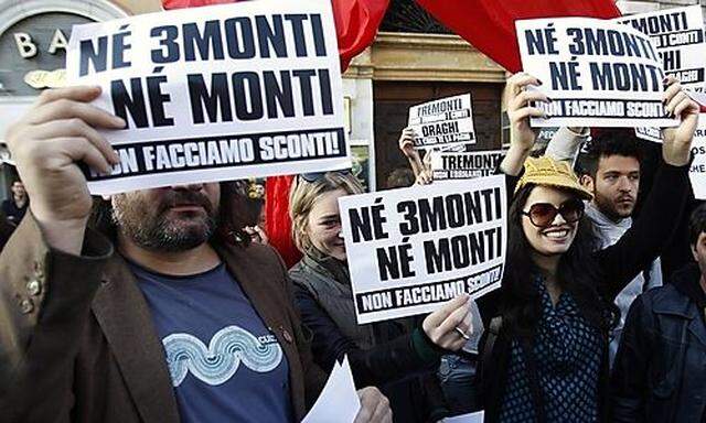 Protesters hold signs reading Neither Tremonti nor Monti during a protest in Rome