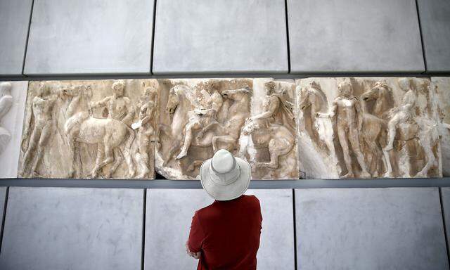 FILE PHOTO: A man looks at exhibits at the Parthenon hall of the Acropolis museum in Athens