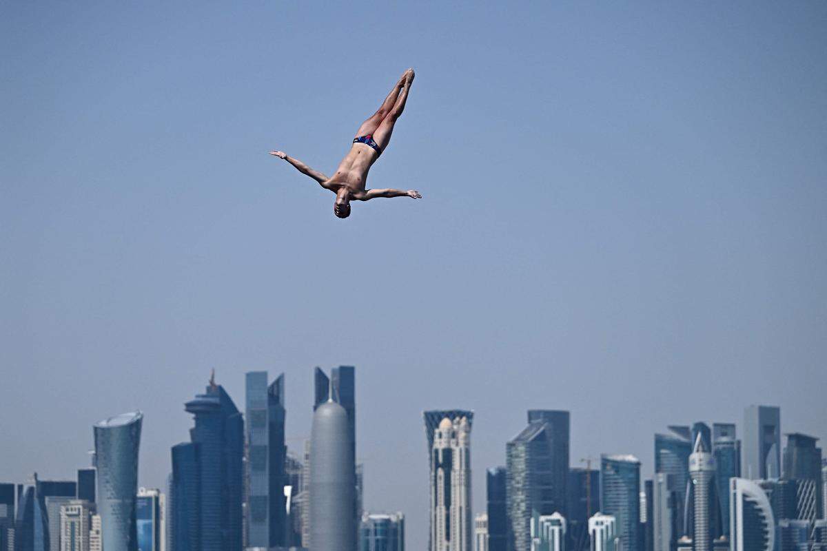 15. Februar. Der Brite Aidan Heslop beim Turmspringen vor der Skyline in Doha, wo gerade Weltmeisterschaften stattfinden.