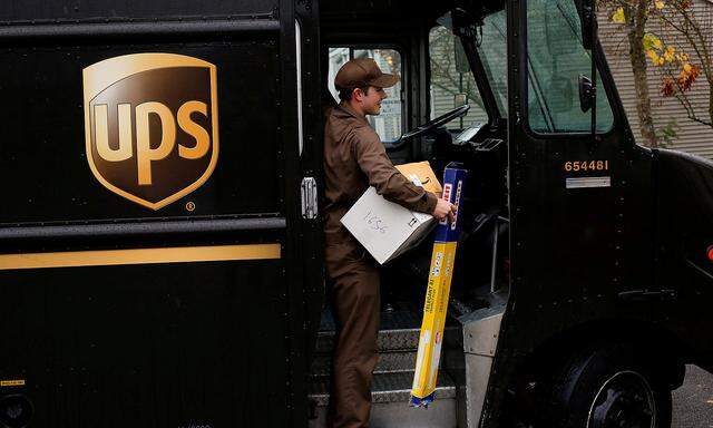 FILE PHOTO: Forrest Lampe-Martin unloads packages during a UPS delivery