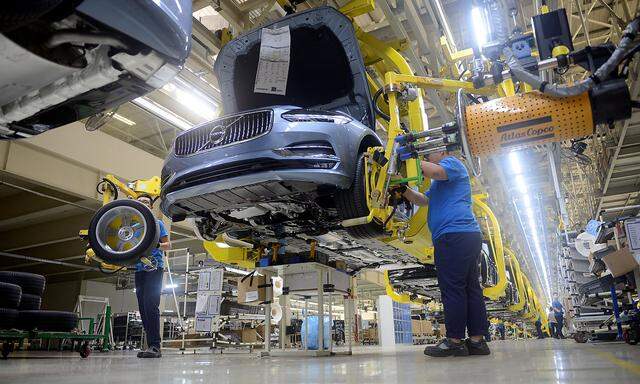 Workers assemble a car at the Volvo Cars manufacturing plant in Daqing