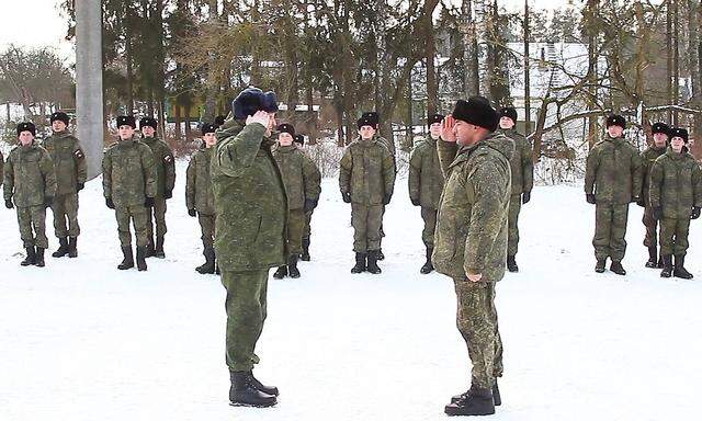 BELARUS - JANUARY 24, 2022: Servicemen are seen after unloading military equipment and hardware of artillery detachments