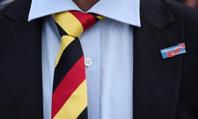 A man with a tie in German national colours wears a pin of the anti-immigrant Alternative for Deutschland (AfD) during the state election Mecklenburg-Vorpommern in Schwerin