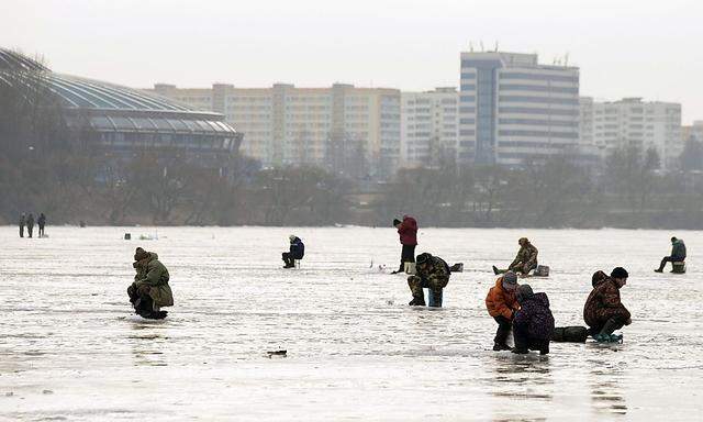 People fish at a frozen lake in Minsk