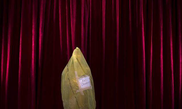 An Oscar statue is seen covered in protective plastic as preparations are underway for the 87th Academy Awards in the H