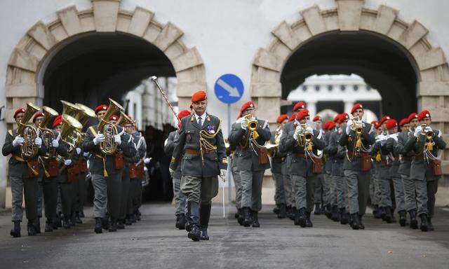Members of Austrian armed forces parade in the inner yard of Hofburg Palce in Vienna