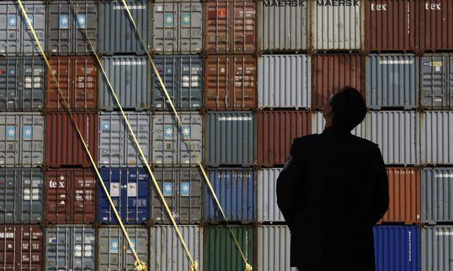 Security guard stands in front of the Yantian International Container Terminal in the southern Chinese city of Shenzhen