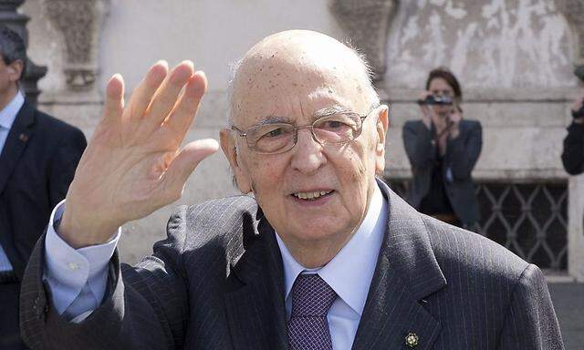 Italian President Napolitano waves at the end of a meeting with the 'wise men' at the Quirinale palace in Rome