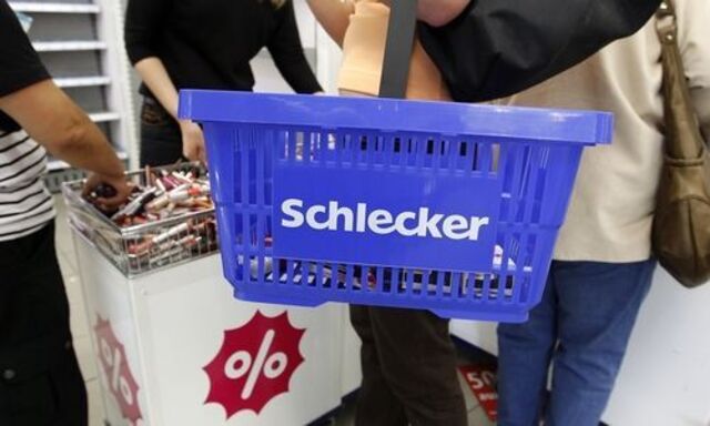 A woman holds a shopping basket during the last day of the closing down sale at a Schlecker drugstore in Munich