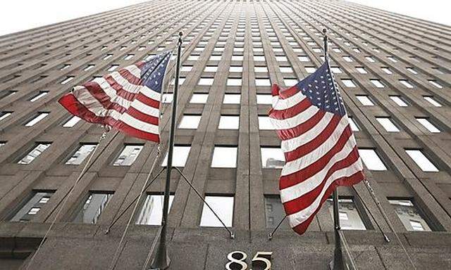 Flags fly outside of the Goldman Sachs headquarters building in the financial district of New York