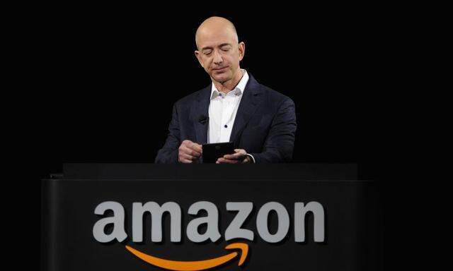 File photo of an Amazon CEO Bezos demonstrating the Kindle Paperwhite during Amazon's Kindle Fire event in Santa Monica