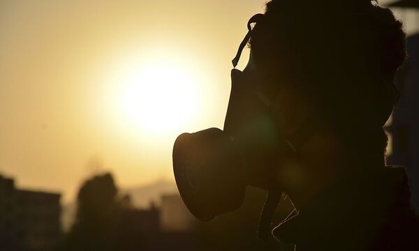 An activist wearing a gas mask is seen in Zamalka area, where activists say chemical weapons have been used by forces loyal to President Bashar Al-Assad in the eastern suburbs of Damascus