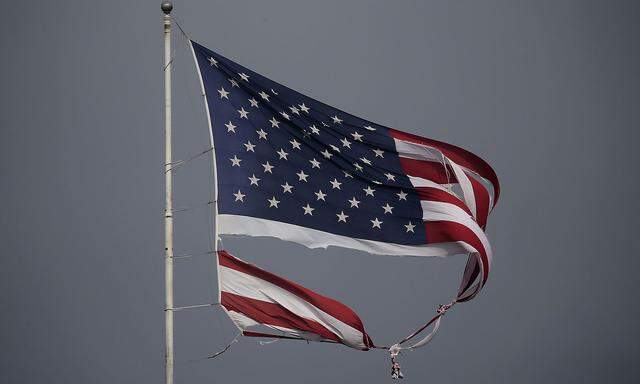 A tattered U.S. flag damaged in Hurricane Harvey, flies in Conroe, Texas