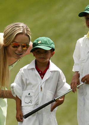 U.S. golfer Woods´ girlfriend Vonn speaks with Woods´ son Charlie and daughter Sam during the par 3 event held ahead of the 2015 Masters at Augusta National Golf Course in Augusta