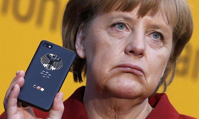 File photo of German Chancellor Merkel holding a BlackBerry Z10 smartphone at CeBit computer fair in Hanover