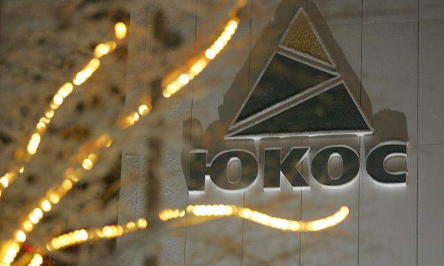 Yukos logo is seen on the wall of the headquarters building after sunset in the Russia´s northern ...