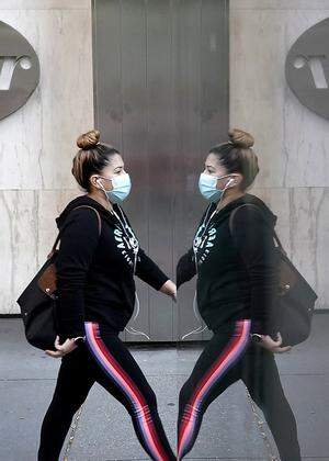 A person walks past the Pfizer Headquarters building