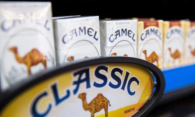 Camel cigarettes are stacked on a shelf inside a tobacco store in New York