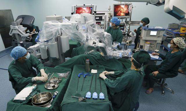 Doctors operate on a patient with a surgical robot in Hefei
