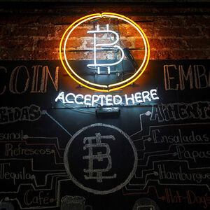 A neon logo of virtual cryptocurrency Bitcoin is seen at the Bitcoin Embassy bar in this illustration