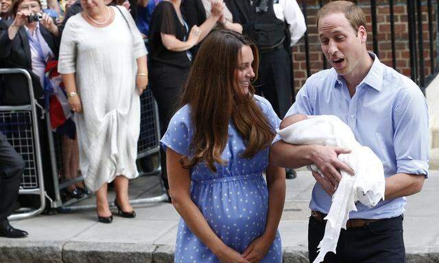 Britain's Prince William and his wife Catherine, Duchess of Cambridge appear with their baby son, as they stand outside the Lindo Wing of St Mary's Hospital, in central London