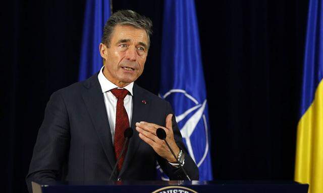 NATO Secretary-General Anders Fogh Rasmussen gestures during a joint news conference at Cotroceni Presidential Palace in Bucharest