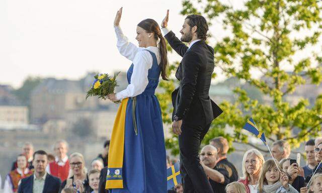 Prince Carl Philip and his fiancee Sofia Hellqvist wave during the Sweden National Day celebrations in Stockholm