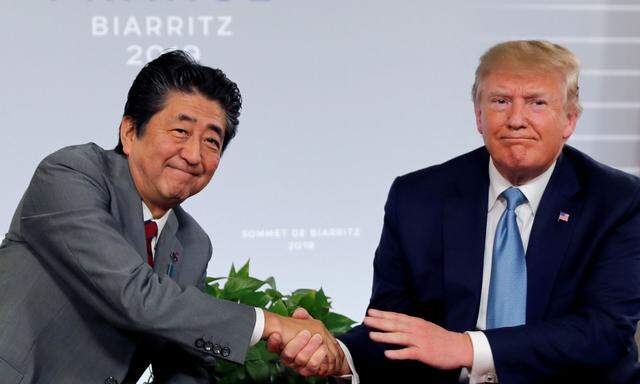 FILE PHOTO: U.S. President Trump and Japan's Prime Minister Abe shake hands at a bilateral meeting during the G7 summit in France