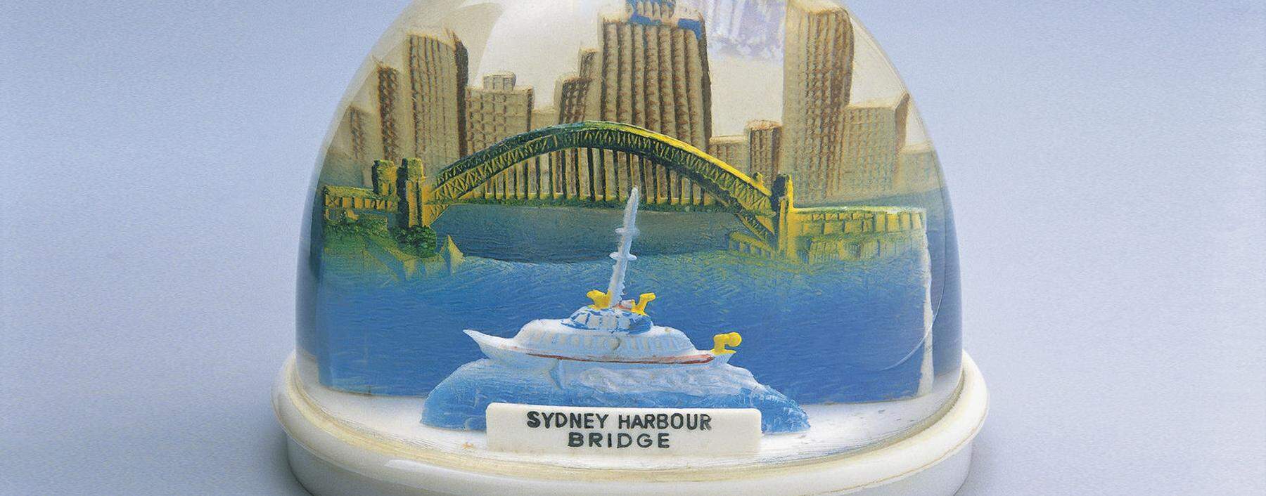 Close-up of a figurine of Sydney Harbor Bridge in a snow globe