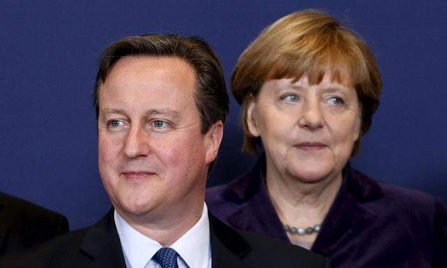 Britain´s PM Cameron and Germany´s Chancellor Merkel pose for a family photo during a EU leaders summit in Brussels