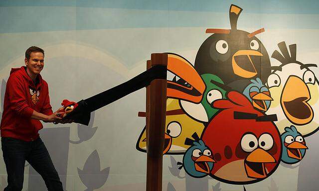 Rovio Entertainment Senior Vice-President Holm poses with Angry Birds toys during news conference in Hong Kong