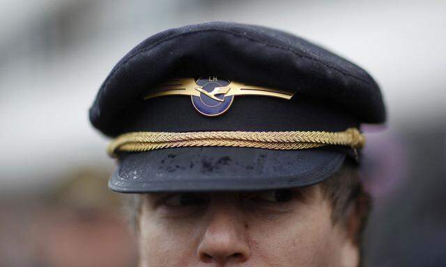 A member of the German Lufthansa pilots union Vereinigung Cockpit (VC) attends a demonstration in front of Frankfurt Airport