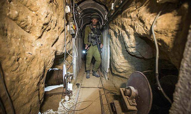 Israeli army officer gives explanations during an army organised tour in a tunnel said to be used by Palestinian militants for cross-border attacks