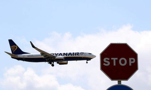 A Ryanair airplane passes a Stop sign as it lands at Barcelona-El Prat airport