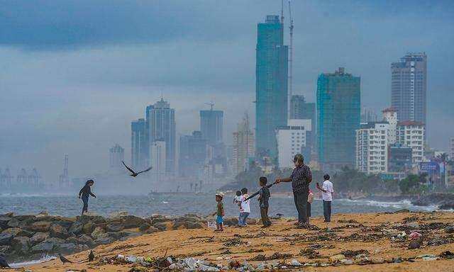 Daily Life In Sri Lanka People are walking on the beach. A large amount of waste can be seen washed ashore in Colombo, S