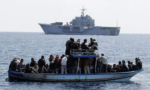 People fleeing the unrest in Tunisia transfer onto the Italian Navy´s amphibious transport dock MM San Marco, off the southern Italian island of Lampedusa