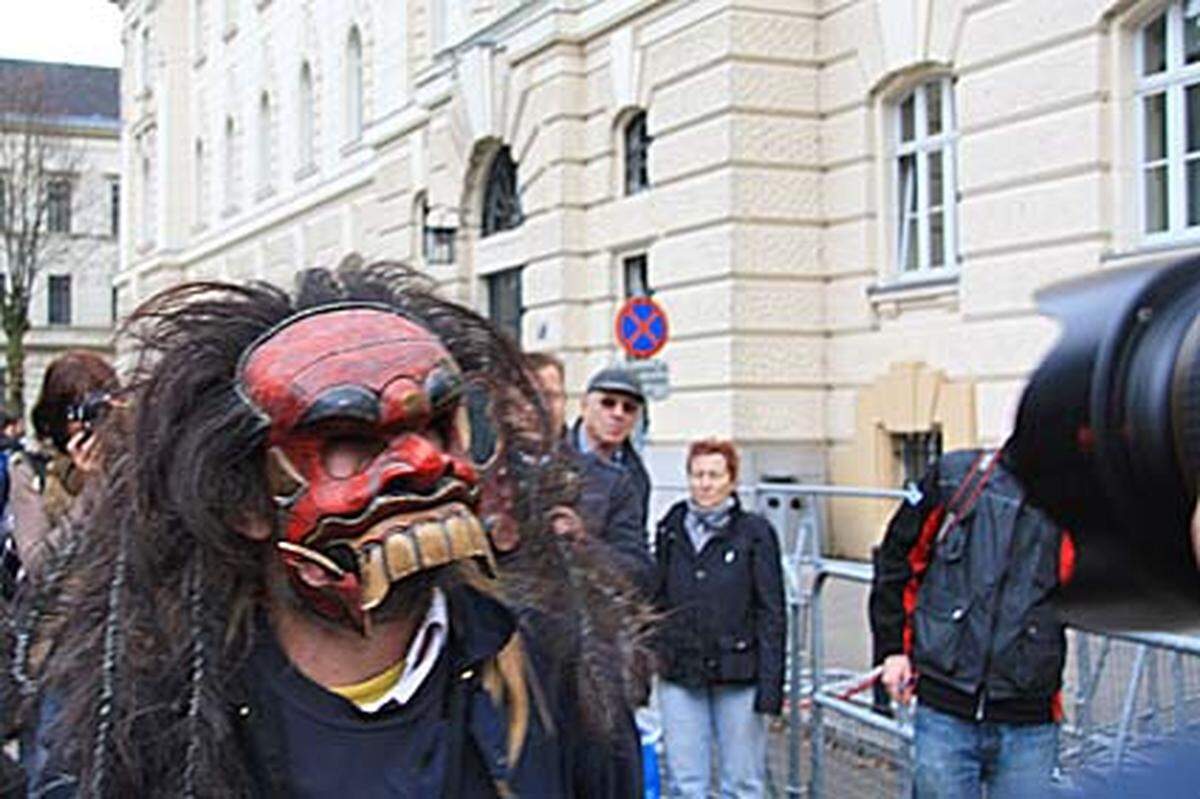 Dieser Mann mit Affen-Dämonen-Maske zieht mit seinem lauten Gebrüll "Österreich ist geil!" und der einen oder anderen Obszönität die Aufmerksamkeit der Fotografen auf sich, ...