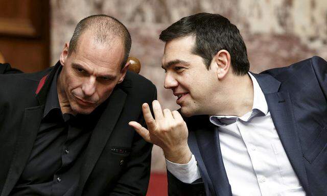 File photo of Greek Prime Minister Tsipras and Finance Minister Varoufakis talking during the first round of a presidential vote at the Greek parliament in Athens