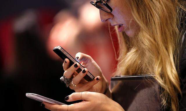 A woman uses a smartphone in New York City