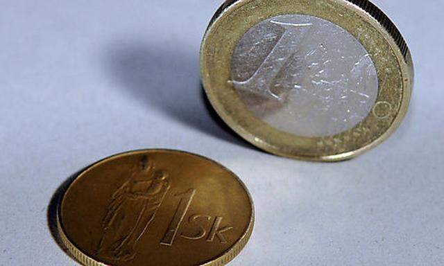 1 Slovak crown coin, left, and 1 euro coin, right, shown together in Bratislava on Tuesday, Dec. 30, 