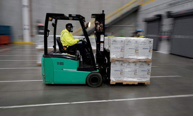 FILE PHOTO: Boxes containing the Pfizer-BioNTech COVID-19 vaccine are prepared to be shipped at the Pfizer Global Supply Kalamazoo manufacturing plant in Portage