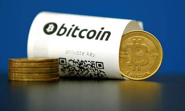 An illustration photo shows a Bitcoin (virtual currency) paper wallet with QR codes and a coin are seen at La Maison du Bitcoin in Paris