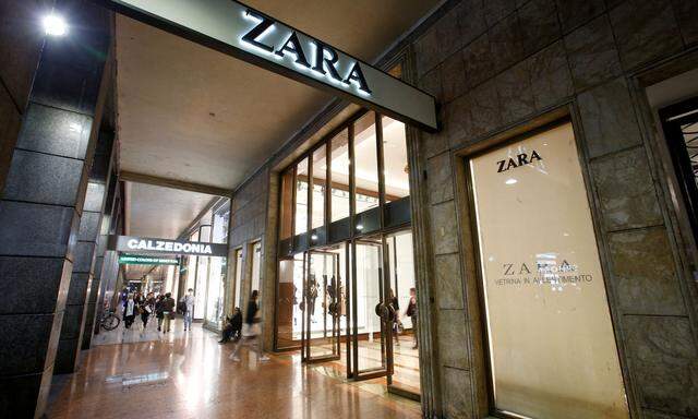 FILE PHOTO: People are seen outside of an Inditex owned Zara store in Milan