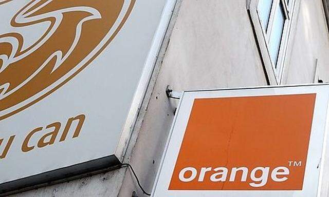 The logos of Orange and 3 are pictured outside a telecommunications store in Vienna