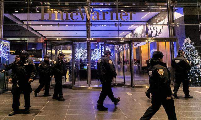 NYPD officers stand near the Time Warner Center Building after the building was evacuated due to a bomb threat, in the Manhattan borough of New York City