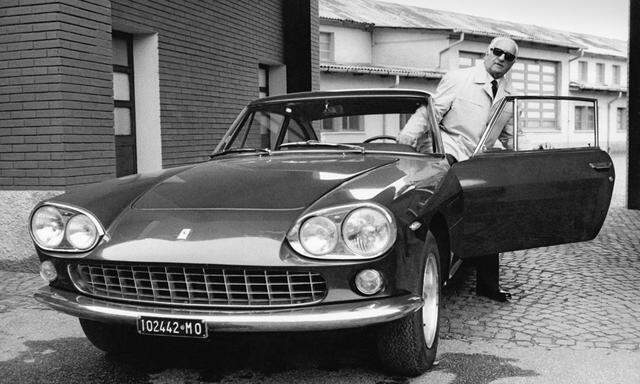 Enzo Ferrari with a Ferrari car